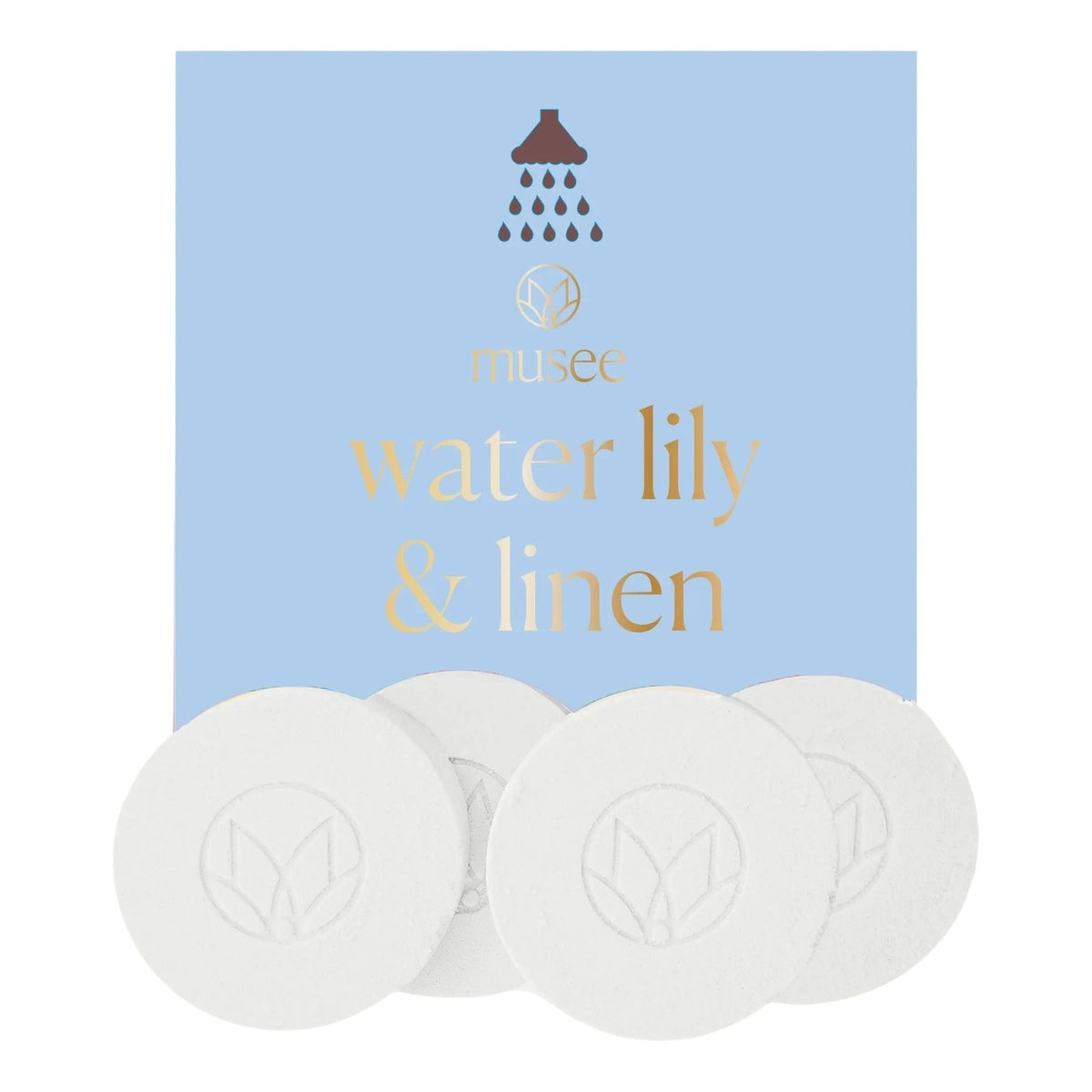 A blue box labeled “MUSEE - WATER LILY & LINEN SHOWER STEAMERS” from MUSEE sits behind five round white tablets, each embossed with a delicate leaf design. These shower steamers offer a spa-like escape, infused with the gentle scent of water lily. Above the text on the box, a small showerhead icon is featured.