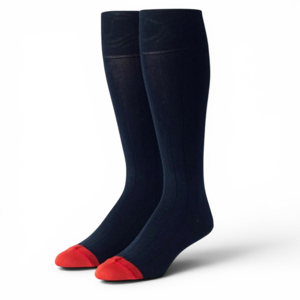 The EDWARD ARMAH - NAVY RED RIB SOCK features knee-high, ribbed navy socks with bright red toes, crafted from luxurious Mercerized Peruvian Pima Cotton and displayed upright on a plain white background.