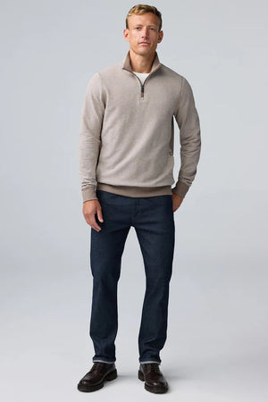 A man wearing a tan Mack Weldon ACE QUARTER ZIP French terry pullover with ribbed cuffs and hem.