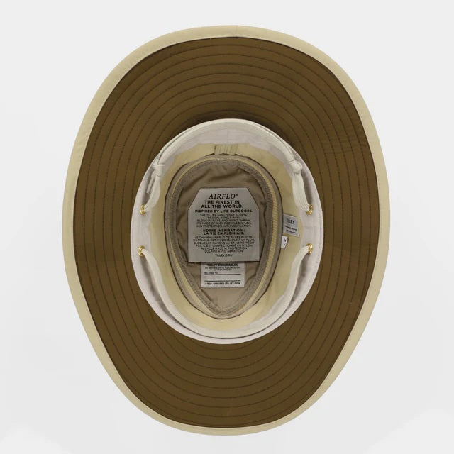 The TILLEY AIRFLO Broad Brim Hat LTM6 in Khaki Olive features mesh ventilation around the crown for outdoor use. Shown on a plain light background, this wide-brimmed sun protection hat is crafted by TILLEY.