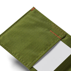 A close-up of the ALLETT Sport Wallet in Cala Green shows its green RFID-blocking ripstop nylon, visible stitching, and a white card partially tucked into one pocket.