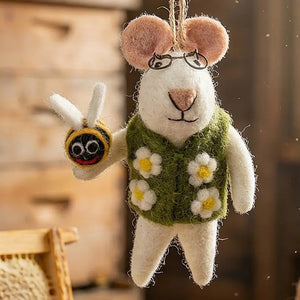 ISAAC THE MOUSE WITH BEE ORNAMENT is a sustainable felt mouse wearing glasses and a green vest with white flowers, holding a small felt bee as a charming Springtime mascot.