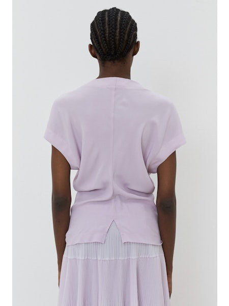 The image portrays a solid black square with a textured, slightly uneven surface. With subtle shading variations, it seems to be a photograph perfectly capturing the minimalist essence of the MEIMEIJ - CAP SLEEVE TOP from the MEIMEIJ brand.