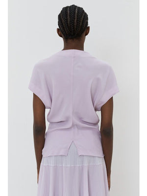 The image portrays a solid black square with a textured, slightly uneven surface. With subtle shading variations, it seems to be a photograph perfectly capturing the minimalist essence of the MEIMEIJ - CAP SLEEVE TOP from the MEIMEIJ brand.