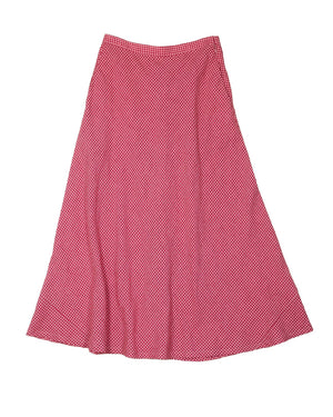 Close-up of a red and white checkered fabric with a wavy texture, featuring an A-line cut. This classic gingham pattern evokes timeless elegance reminiscent of THE LITTLE PROJECT's Marnie Skirt in Fruit Punch Gingham.