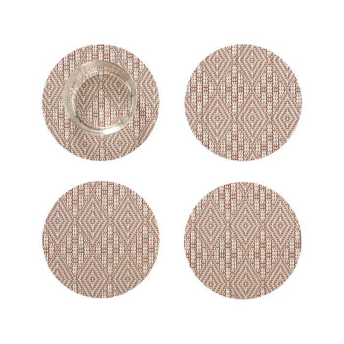 The CHILEWICH - BOXWOOD BACKED COASTER SET4 features four round coasters in brown and beige with a geometric diamond pattern and lace-like weave. One holds a clear glass, while the others are arranged in a grid. By CHILEWICH.