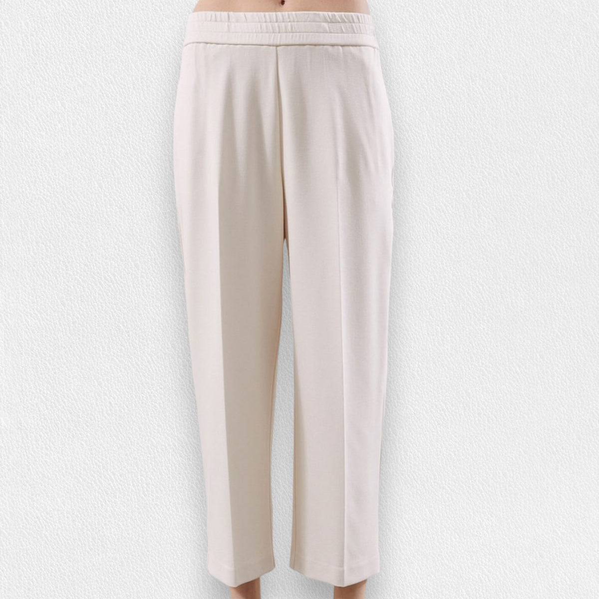 The MEIMEIJ - PONTE PULL ON TROUSER, a pair of beige, high-waisted, straight-leg pull-on trousers from MEIMEIJ, is displayed against a light textured background. These pants feature an elastic waistband, side pockets, and a simple, minimalist design.