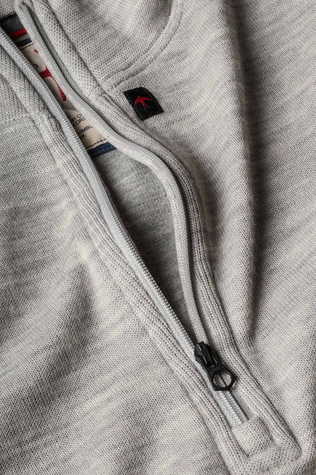 RELWEN - Wool and Cotton Quarter Zip in Light Grey Heather, a long-sleeve pullover sweater from RELWEN, is laid flat on a white background. This lightweight, layer-ready sweater features a soft, slightly textured double-faced knit fabric and displays a visible tag near the quarter-zip collar.