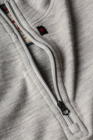 RELWEN - Wool and Cotton Quarter Zip in Light Grey Heather, a long-sleeve pullover sweater from RELWEN, is laid flat on a white background. This lightweight, layer-ready sweater features a soft, slightly textured double-faced knit fabric and displays a visible tag near the quarter-zip collar.