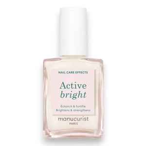A nail polish brush and swatches appear beside text featuring the MANUCURIST - ACTIVE™ BRIGHT TREATMENT POLISH by MANUCURIST INC, emphasizing easy application, fast drying, a buildable make-up effect, and an enriched formula with active ingredients—perfect for plant-based nail care or as a brightening treatment polish.