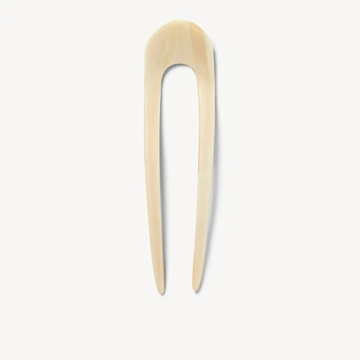 The MACHETE French Hair Pin in Alabaster features a smooth, cream hue with two long, tapered prongs and a rounded top. This stylish accessory by MACHETE is handcrafted and shown against a clean white background.