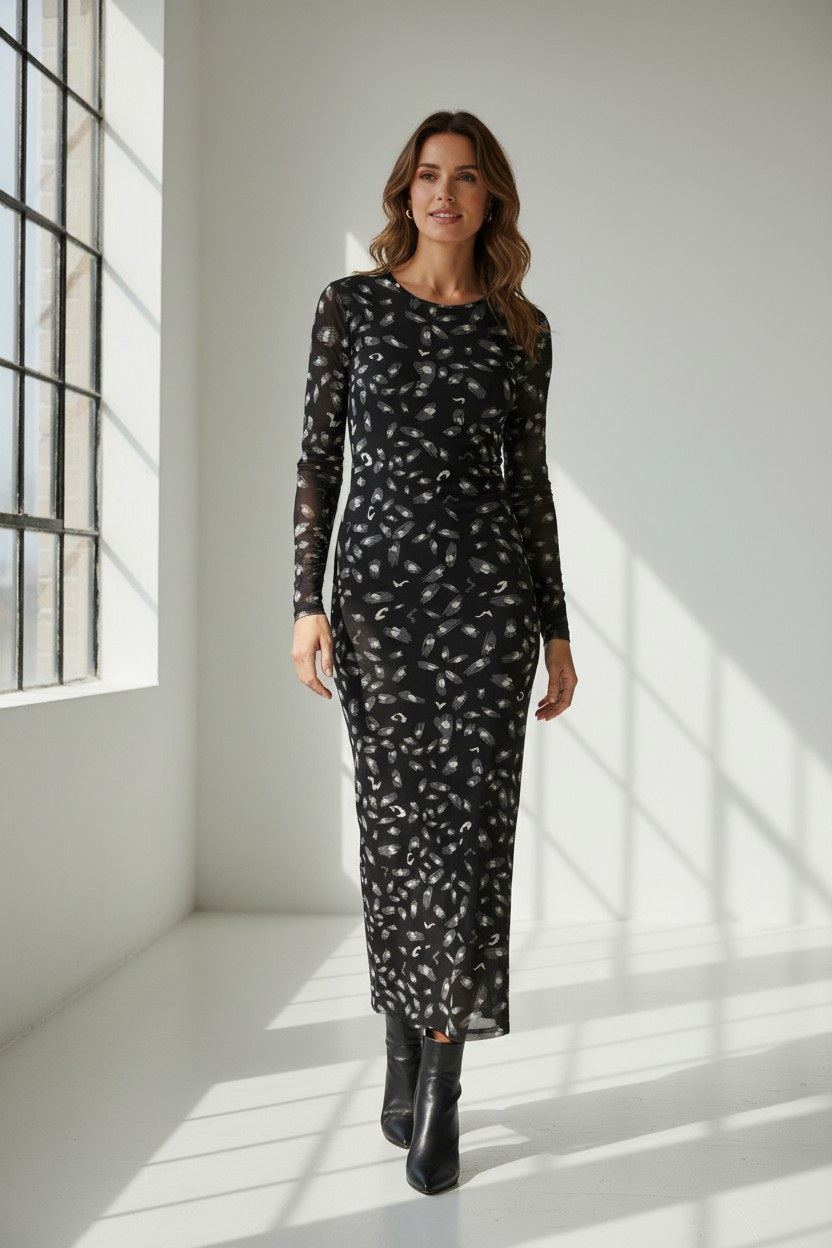 The FRANCO FERRARI BALLET MESH MAXI DRESS is a long-sleeved, ankle-length black stretch mesh dress with a sheer overlay featuring scattered gray and white abstract patterns, shown against a white background.