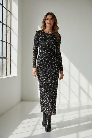 The FRANCO FERRARI BALLET MESH MAXI DRESS is a long-sleeved, ankle-length black stretch mesh dress with a sheer overlay featuring scattered gray and white abstract patterns, shown against a white background.