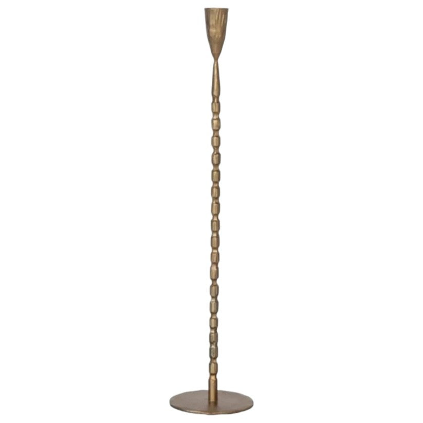 The CREATIVE COOP CAST IRON TAPER HOLDER IN BRASS FINISH, LARGE, features a tall, slender design with a textured segmented stem and round base, perfect for displaying a single taper candle.