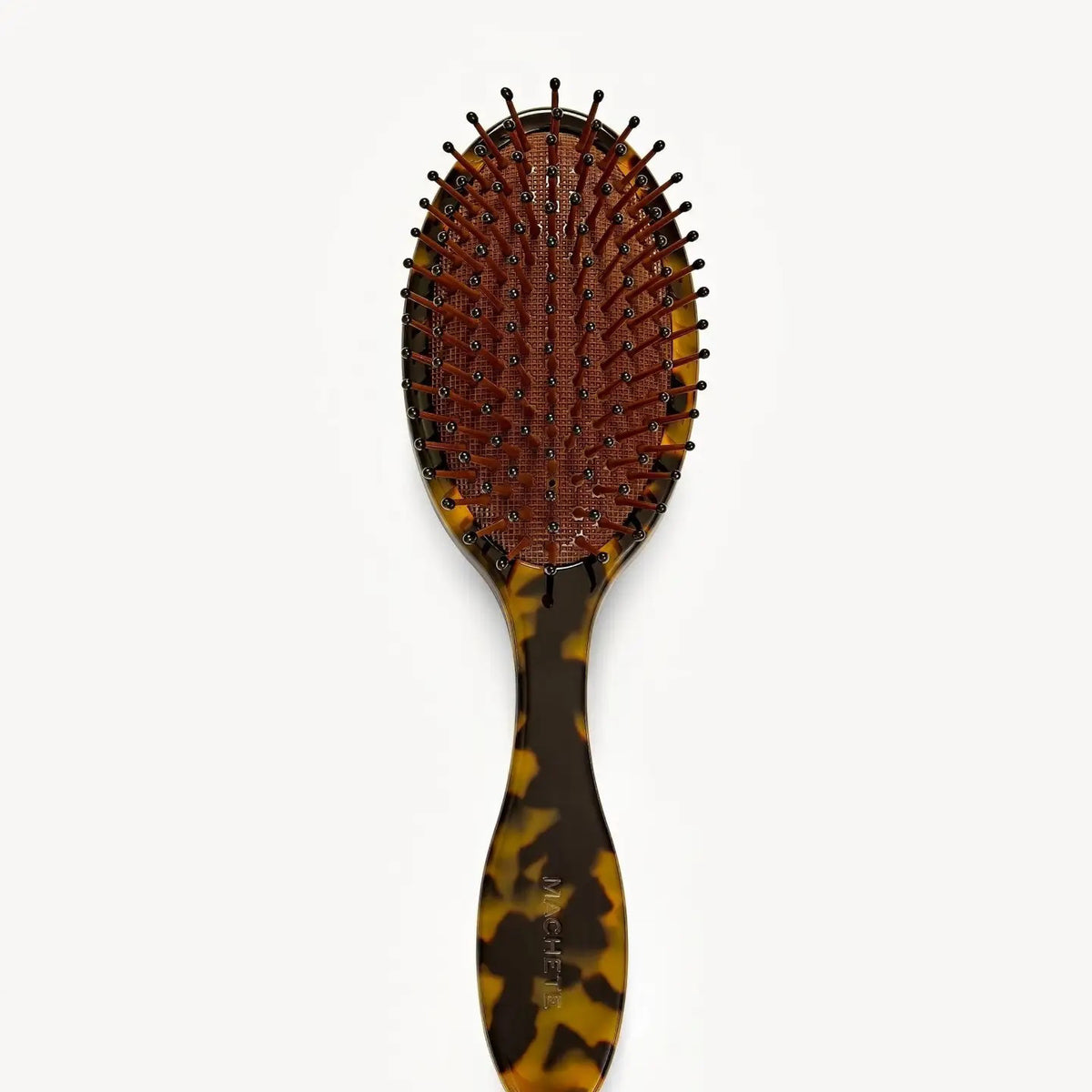 The MACHETE Everyday Detangling Hair Brush in Tortoise is a brown tortoiseshell Italian acetate brush with a dark bristle bed and rounded tips, shown against a plain white background.