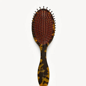 The MACHETE Everyday Detangling Hair Brush in Tortoise is a brown tortoiseshell Italian acetate brush with a dark bristle bed and rounded tips, shown against a plain white background.