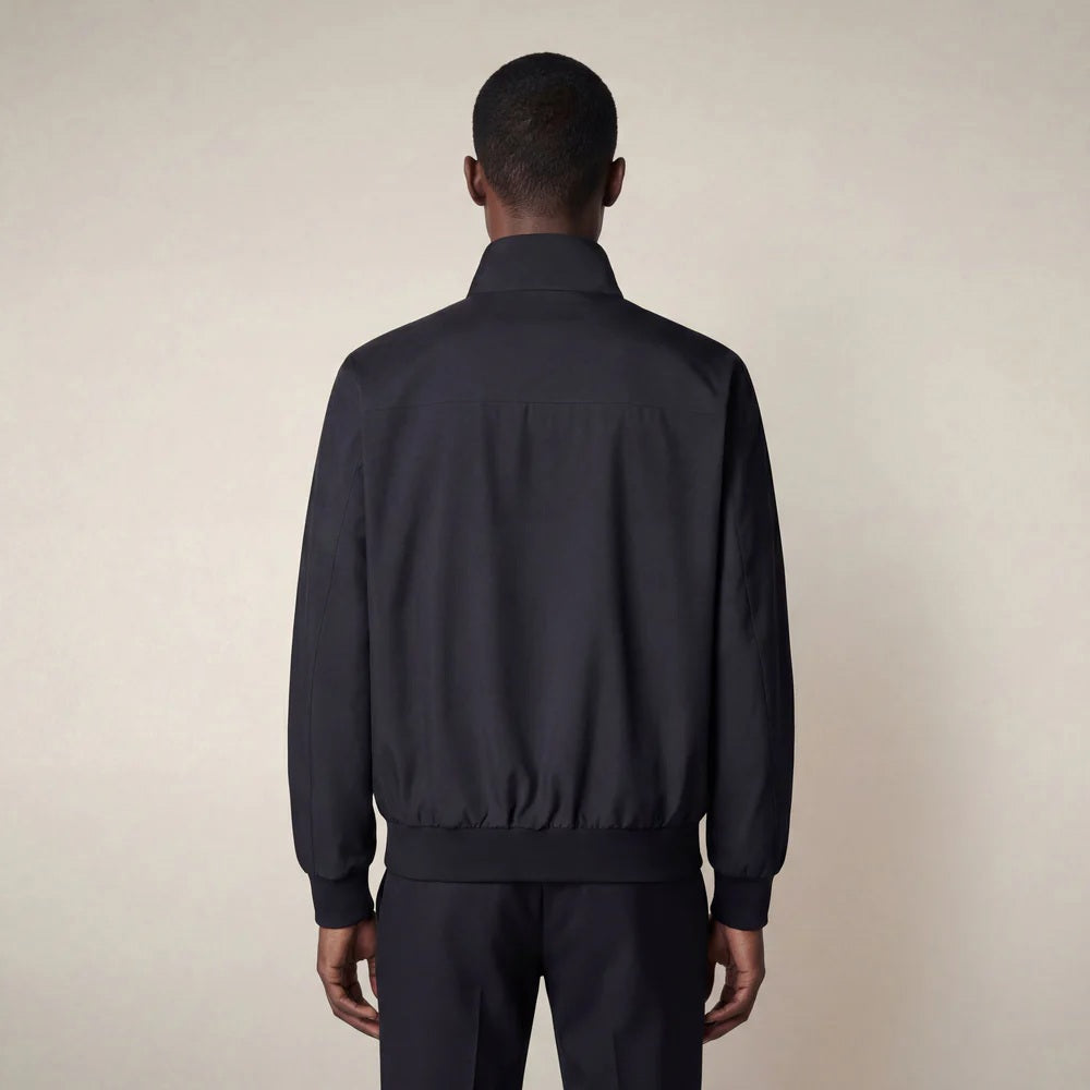 A man stands against a neutral background, wearing the SAVE THE DUCK - FINLAY JACKET IN BLUE BLACK with matching black shirt, trousers, and shoes. He has a neutral expression and his arms rest at his sides.