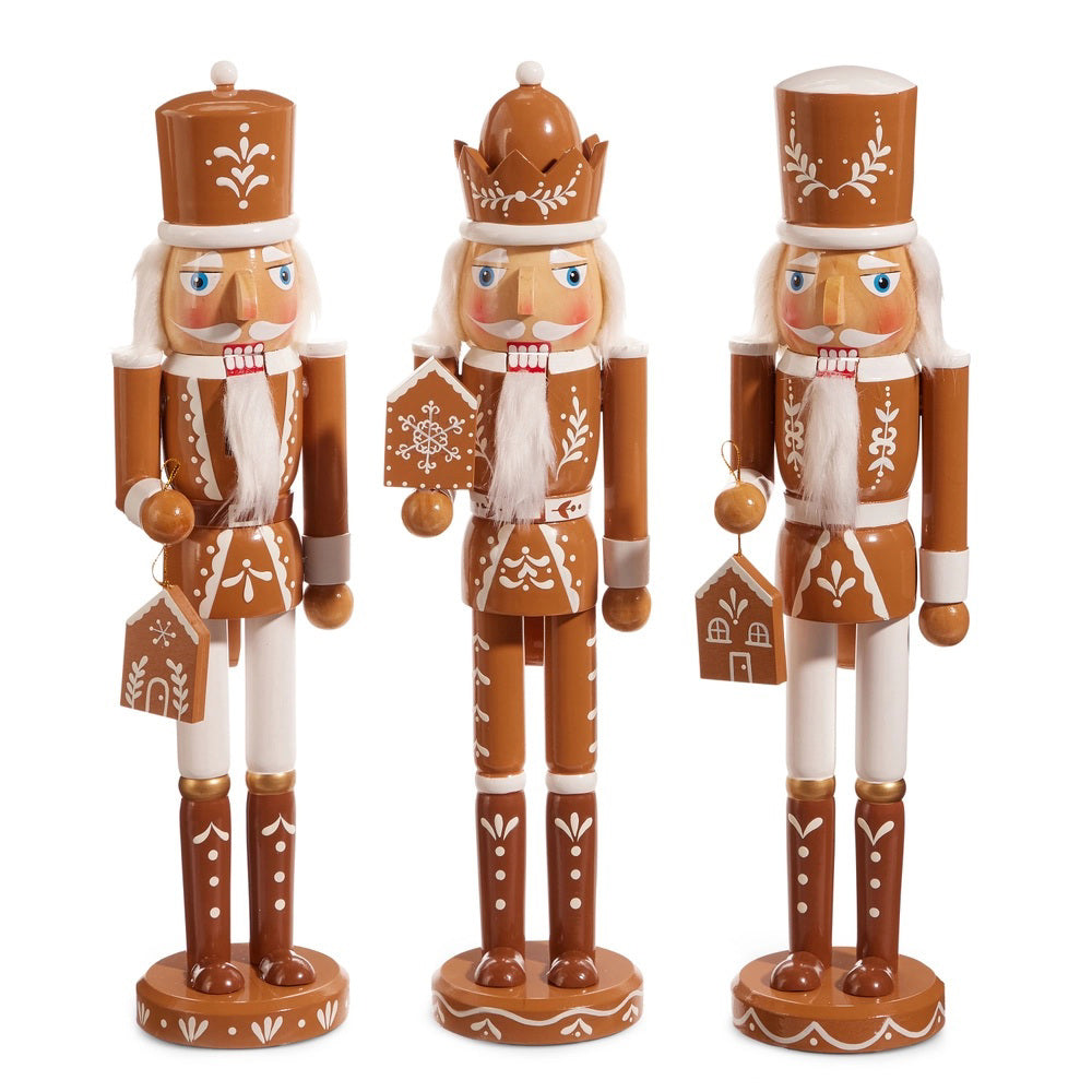 The RAZ IMPORTS GINGERBREAD NUTCRACKERS are three brown figurines with white icing-style designs, each holding a unique gingerbread house accessory—perfect for charming wooden holiday decor.