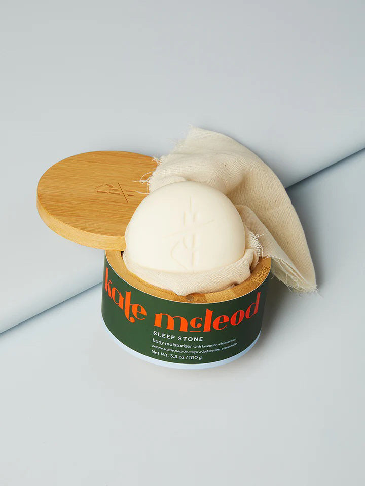 An image comparing “The Kate McLeod Difference” between the Sleep Stone Deep Moisturizing Lotion Bar and typical body lotion. The Sleep Stone, rich with cocoa butter and plant oils, contrasts with average lotions that mainly use water and synthetics.