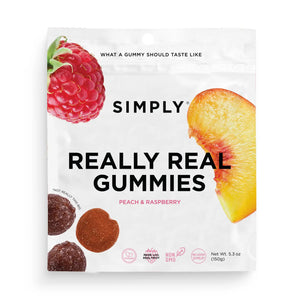 A 5.3oz bag of SIMPLY GUM - REALLY REAL PEACH RASPBERRY GUMMIES features images of raspberries, peach slices, and gummy candies on a white background. The packaging highlights non-GMO and plant-based qualities, is made with real fruit, and contains no artificial flavors.