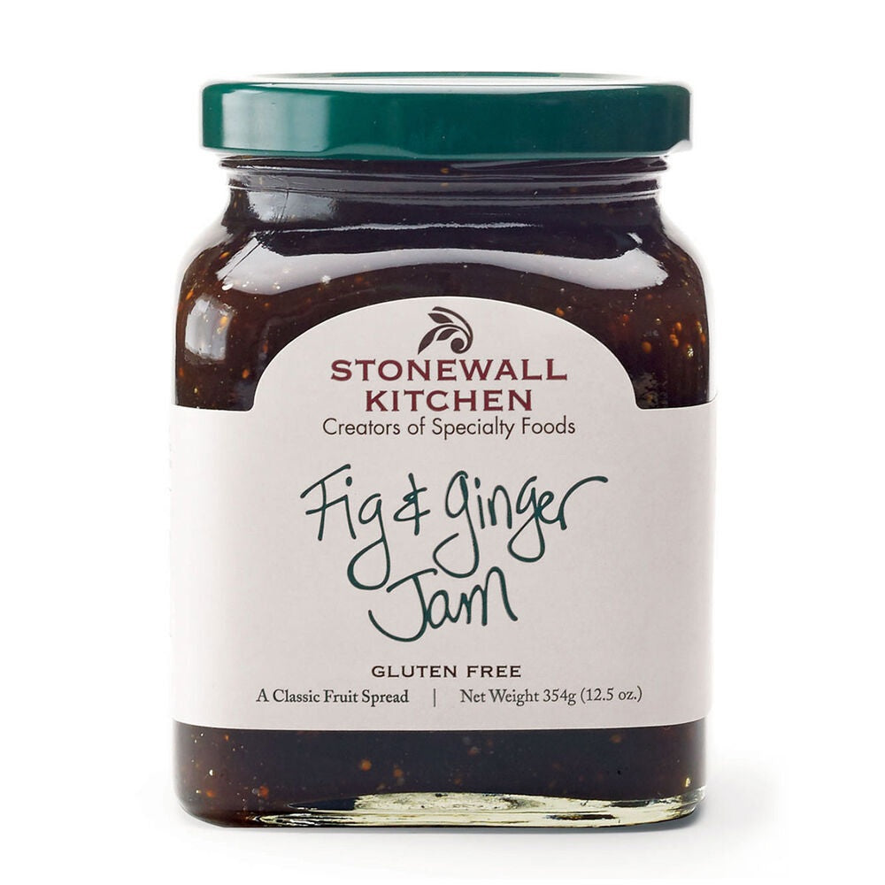 A glass jar of STONEWALL KITCHEN - FIG AND GINGER JAM, featuring a green lid and a white label with product details—ideal for spreading on breakfast breads or infusing marinades and glazes with a sweet-savory flavor.