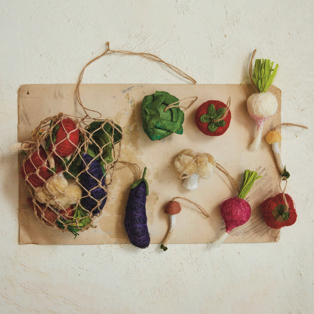 The CREATIVE COOP FOAM VEGETABLE ORNAMENTS SET OF 13 offers colorful faux veggies, ideal for vibrant decor or playful displays.