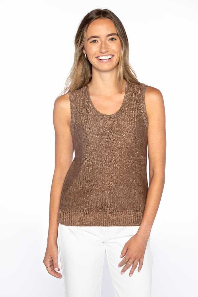 A woman with long, light brown hair smiles in the KINROSS CASHMERE - OPEN TEXTURE LUREX LINEN TANK and white pants, standing against a plain white background.