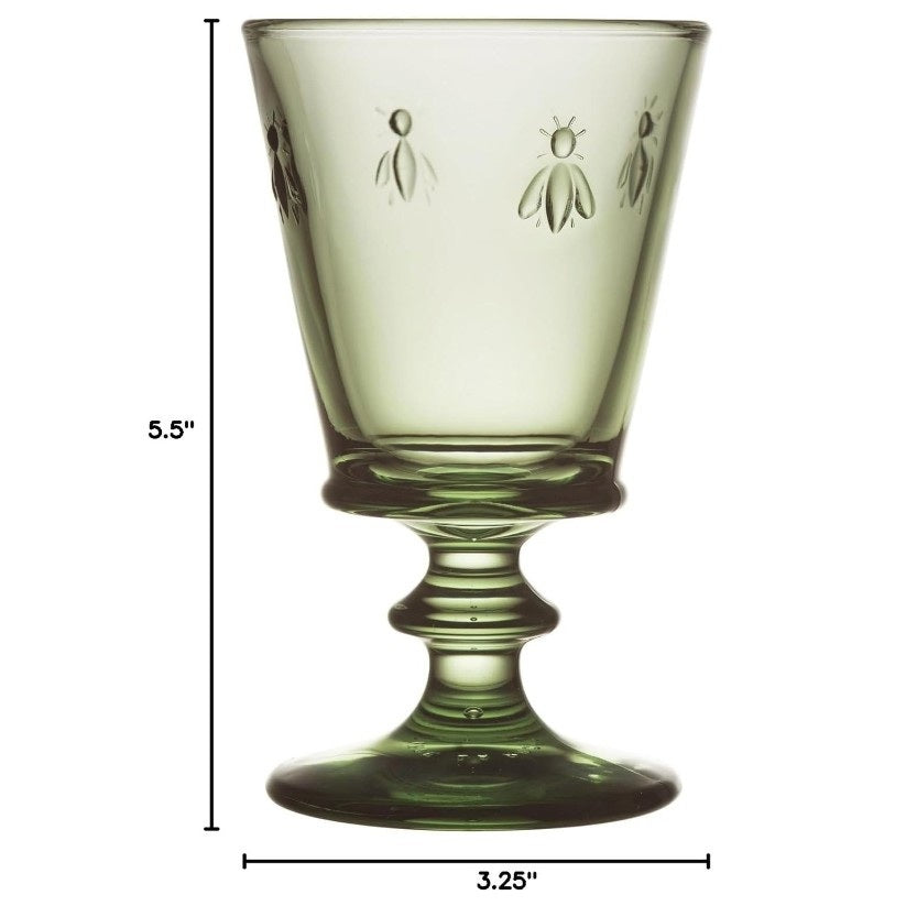 The LA ROCHERE BEE WINE GLASS, OLIVE features embossed bee motifs and an olive hue, inspired by classic Napoleonic stemware, shown on a white background.