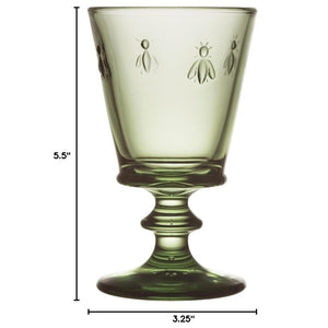 The LA ROCHERE BEE WINE GLASS, OLIVE features embossed bee motifs and an olive hue, inspired by classic Napoleonic stemware, shown on a white background.