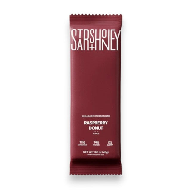 A maroon STARS+HONEY - RASPBERRY DONUT protein bar is shown. This raspberry donut-flavored bar from STARS+HONEY highlights 10g collagen, 14g protein, and only 2g sugar per bar on the front of the package—making it a perfect healthy snack.