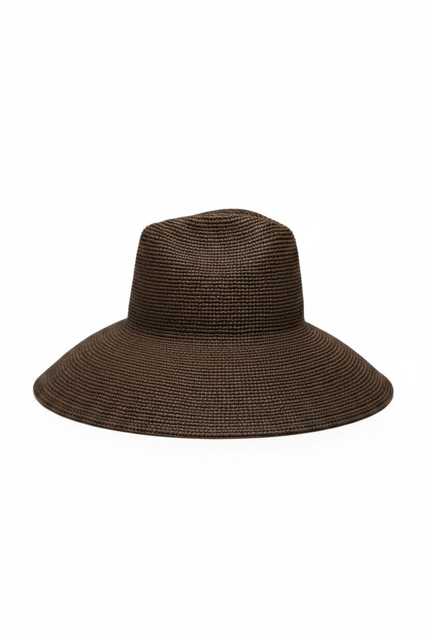 The WYETH Lina Raffia Sun Hat in Chocolate features a packable, ultra wide brim and slightly pointed crown, shown against a plain white background.