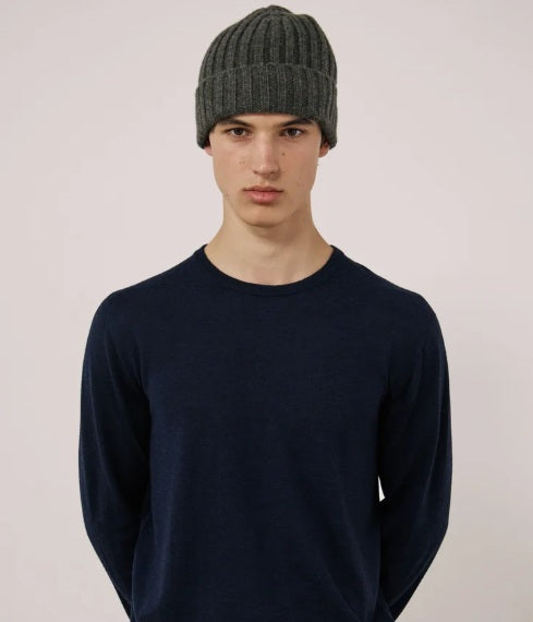 A young person wearing the HARTFORD Cashmere and Wool Beanie in Army looks directly at the camera with a neutral expression, set against a plain white background.