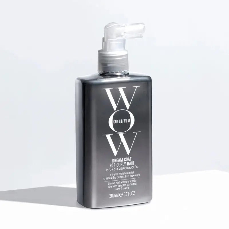 A metallic spray bottle of KT SUPPLY COLORWOW - DREAM COAT FOR CURLY HAIR (200ml) with a gray pump nozzle stands upright on a white surface, showcasing its ultra-light spray curl formula.