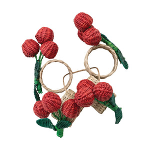 The CREATIVE COOP HAND-WOVEN SEAGRASS CHERRY NAPKIN RINGS, SET OF 4, feature clusters of red cherries and green leaves—ideal as handcrafted table decor and arranged beautifully on any setting.