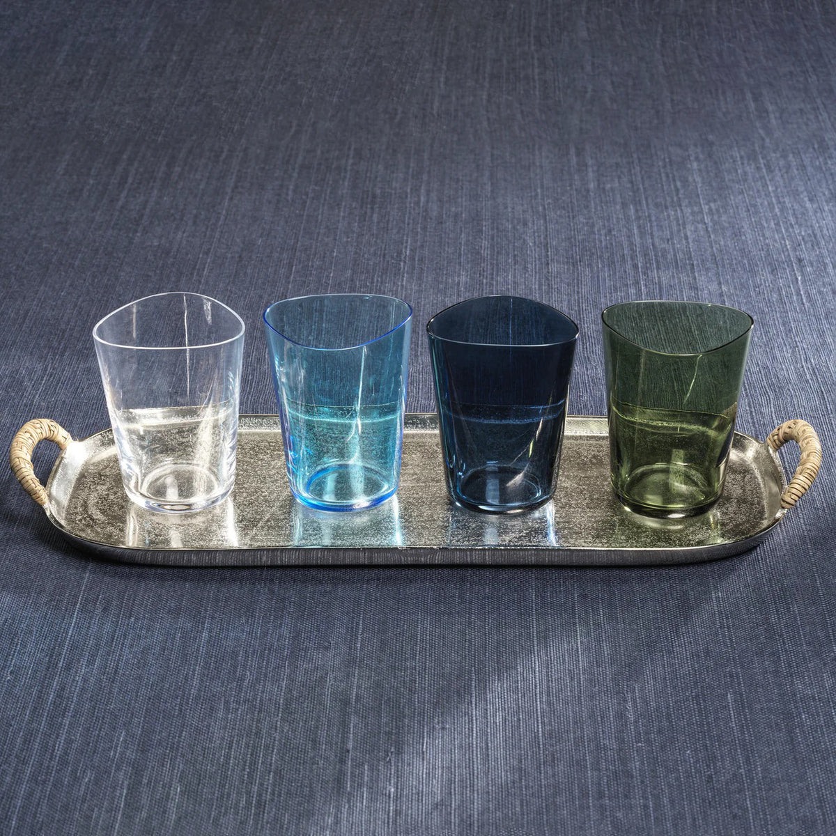 The APERITIVO TUMBLER IN GREEN by ZODAX is a 400 ml soda-lime glass cup with an irregular, organic-shaped rim and a smooth translucent green finish, displayed on a white background.