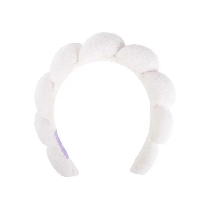 The CAIT &amp; CO PLUSH HEADBAND features six rounded sections resembling soft clouds, arranged in a crown-like fashion. This ultra-soft terry cloth headband has a plush, textured appearance and a clean, simple design. It is perfect for your skincare routine or face washing, making it a whimsical and cozy accessory.