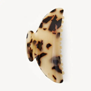 The MACHETE - MIDI HEIRLOOM CLAW by MACHETE is featured against a plain white background. This cream-colored hair accessory is crafted from luxurious Italian acetate and features curved edges with interlocking teeth, making it ideal for securing medium hair with effortless style.