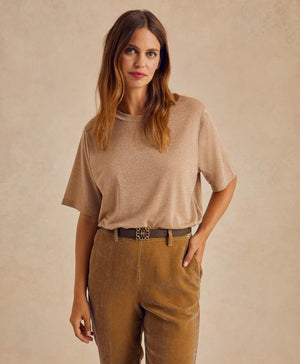 The MOMONI - IORA LUREX JERSEY T SHIRT by MOMONI is a red, short-sleeve, loose-fitting T-shirt with a subtle shimmer. Crafted from soft lurex jersey, this shirt features a round neckline and is made of a soft, lightweight material. Made in Italy. The background is plain white.