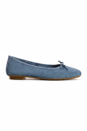 The REQINS Harmony Suede Ballerina Flats in Blue Jean feature luxurious goat suede, a delicate front bow, and a low brown heel, displayed on a plain white background.