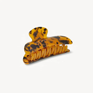 The MACHETE - MIDI HEIRLOOM CLAW IN TORTOISE is a midi hair clip crafted from Italian acetate with a tortoiseshell pattern and interlocking teeth, displayed against a plain white background.