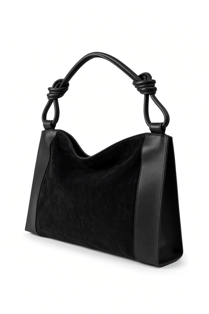 LE BORSETTE LEATHER AND SUEDE HANDBAG IN BLACK featuring leather side panels, a suede body, and a handle with a knotted detail at each end.