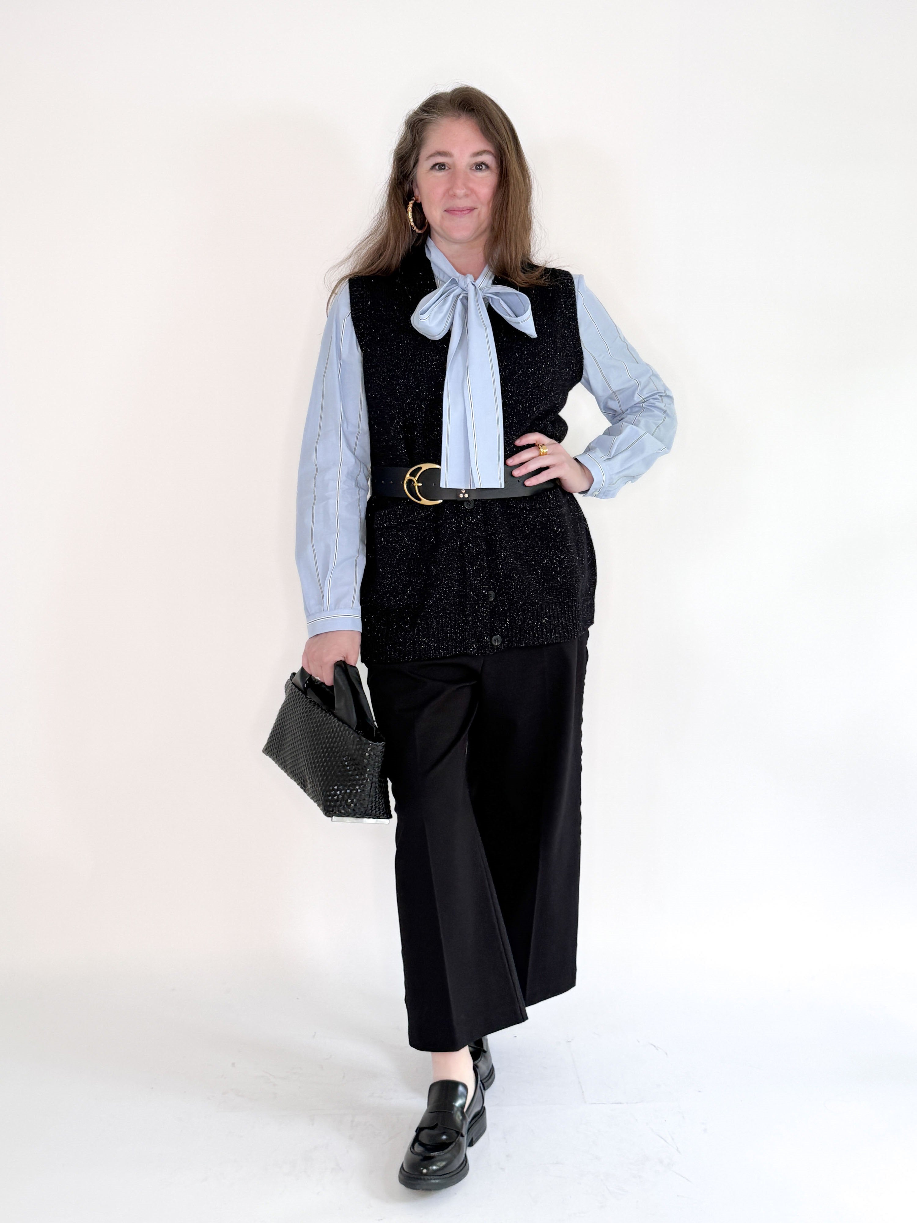 The SEVENTY VENEZIA - GILET VEST by SEVENTY is a sleeveless black knit vest in textured fabric, shown from the back against a plain light background—an elegant Italian-made layering piece.