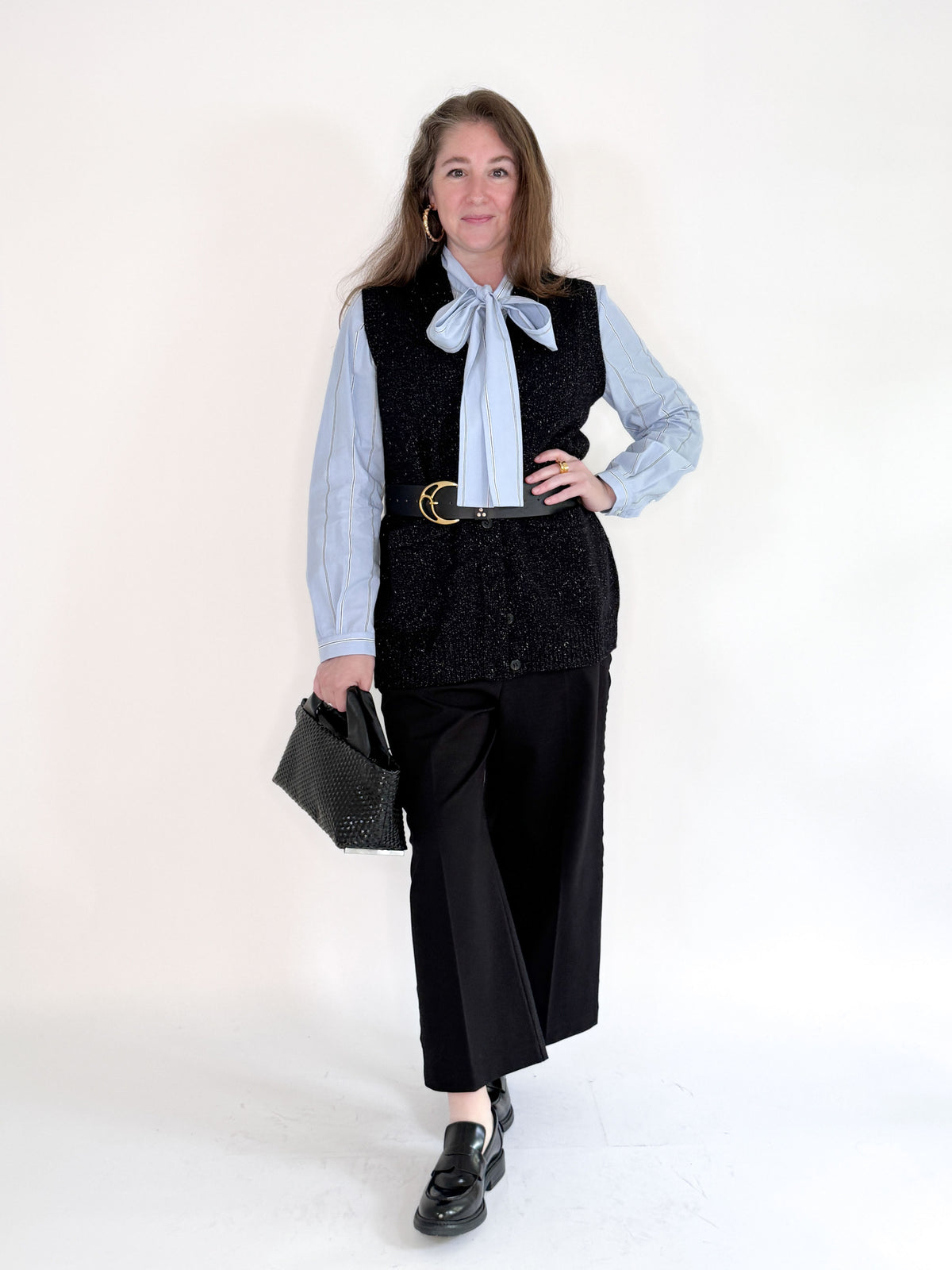 The SEVENTY VENEZIA - GILET VEST by SEVENTY is a sleeveless black knit vest in textured fabric, shown from the back against a plain light background—an elegant Italian-made layering piece.