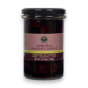 A glass jar labeled “RITROVO SELECTIONS - AMARENA CHERRIES IN BAROLO CHINATO” from RITROVO contains luscious dark Amarena cherries in syrup. The label notes that these cherries are soaked in Barolo Chinato digestive wine, making them an exceptional cocktail garnish. The net weight is 10.58 oz (300g).