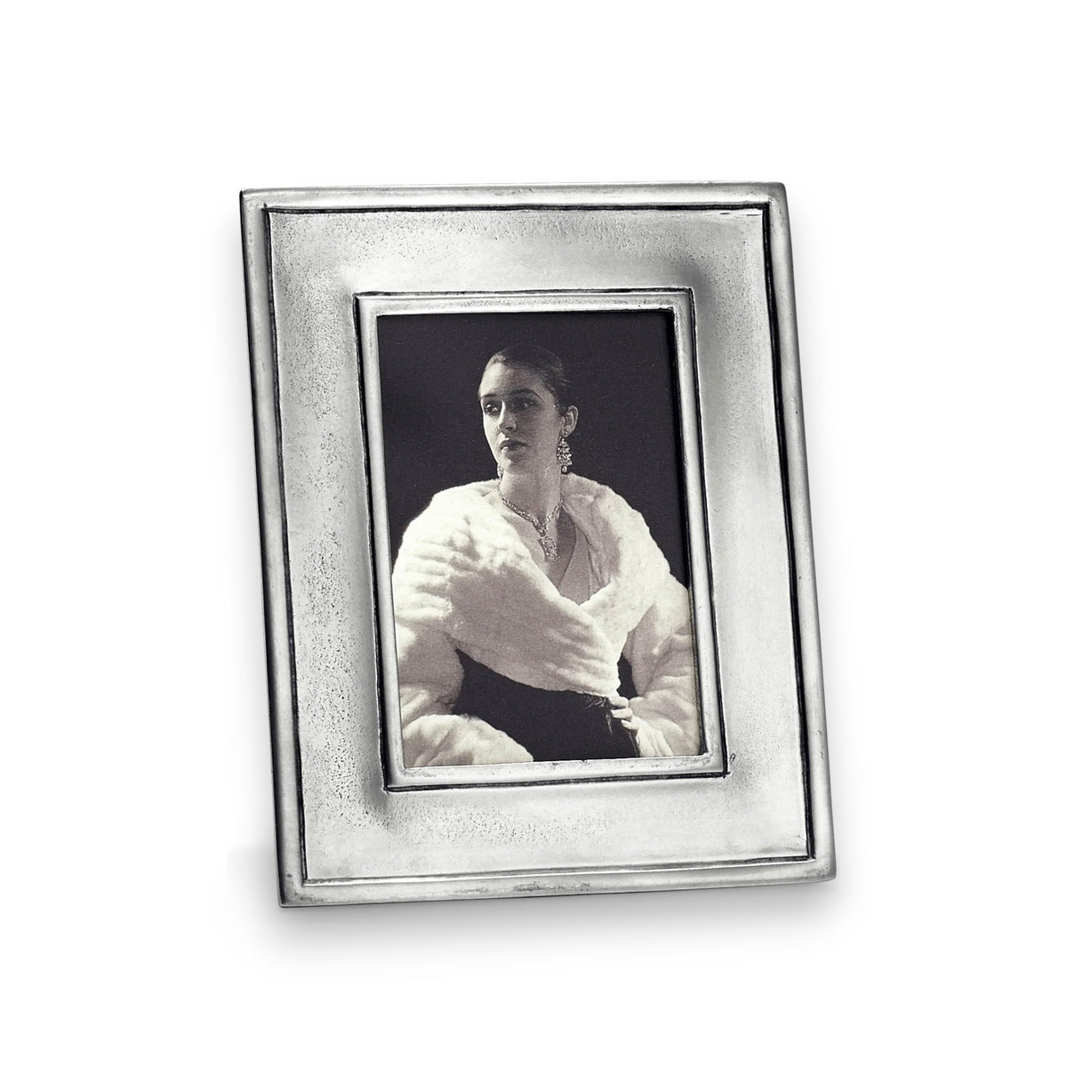 A black-and-white photo of a woman in a fur coat and earrings is shown in the MATCH - LOMBARDIA RECTANGULAR PEWTER PHOTO FRAME SMALL, an elegant MATCH piece with wood backing—perfect for personalized gifts.