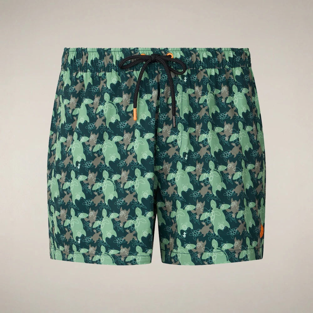 SAVE THE DUCK ADEMIR swim trunks in green and gray turtle camouflage are crafted from recycled polyester, featuring a black drawstring and orange tag. These quick-dry men's shorts are shown on a plain background.