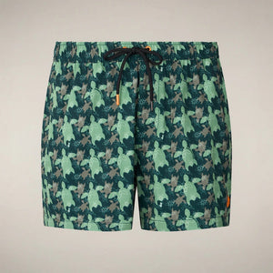 SAVE THE DUCK ADEMIR swim trunks in green and gray turtle camouflage are crafted from recycled polyester, featuring a black drawstring and orange tag. These quick-dry men's shorts are shown on a plain background.