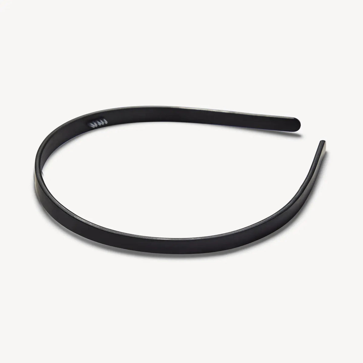 The MACHETE Ultralight Thin Headband in Matte Black is a simple, lightweight accessory crafted from hand-polished Italian acetate, displayed on a plain white background.