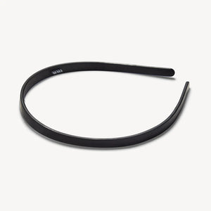 The MACHETE Ultralight Thin Headband in Matte Black is a simple, lightweight accessory crafted from hand-polished Italian acetate, displayed on a plain white background.