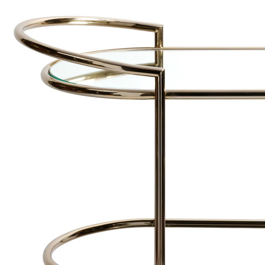 The ZODAX CONSOLE BAR CART showcases a minimalistic design with a shiny gold metal frame, mirrored shelves, curved corners, and clean lines—making it a stylish serving station for any modern space.